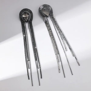 Detail of gunmetal long tassel earrings with dark rhinestones and teardrop crystal