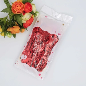 Red foil fringe curtain detail in transparent packaging for party wall decoration
