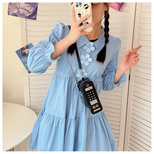 Blue doll-style dress with flower buttons and vintage radio-shaped crossbody bag