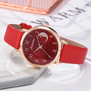 Detail of red starry sky dial and rose gold case on a women's leather quartz watch