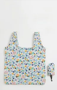 Detail showing the floral folding shopping bag with its matching portable storage pouch