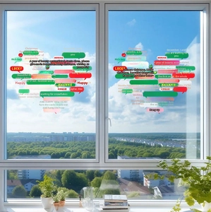 Detail of Christmas heart-shaped window static stickers with festive greetings on glass