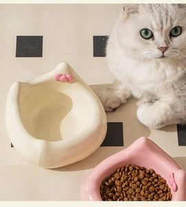 Ceramic tilted cat bowl with pink bow and ergonomic neck protection design for pets