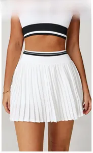 Detail of high-waisted pleated tennis skirt in swan white with striped waistband