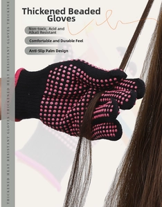 Close-up of heat resistant glove with pink silicone dots holding brown hair strand