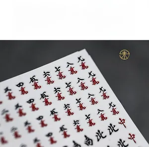 Dettaglio degli adesivi per unghie mahjong 5D con motivi a rilievo rossi e neri