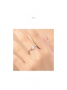 Close-up of minimalist S925 sterling silver ring with heart-shaped cubic zirconia stone