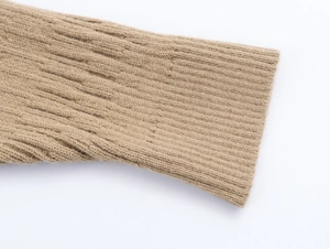 Detailed close-up of khaki ribbed knit texture on the cuff of a cardigan set