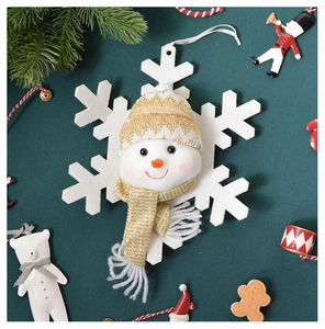 Macro view of plush snowman ornament with knitted hat on white felt snowflake base