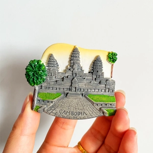 Macro detail of a 3D Cambodia Angkor Wat resin fridge magnet with embossed text