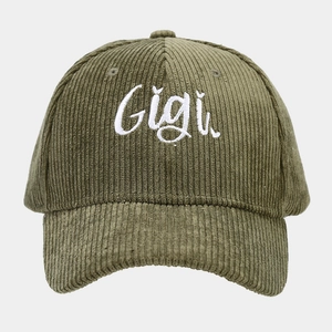 Close-up of green corduroy baseball cap featuring detailed white Gigi embroidery text