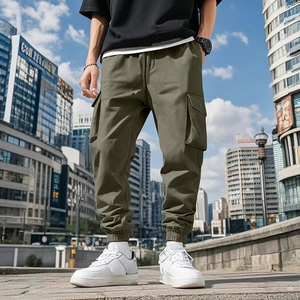 Close-up of olive green men's cargo pants featuring multi-pockets and cuffed ankles