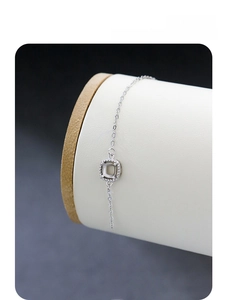 Detailed view of a delicate S925 sterling silver bracelet featuring a square charm