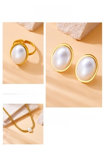 Detailed set of gold-plated stainless steel jewelry with oval pearl accents on stone