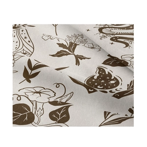 Close-up of bohemian tapestry showing beige fabric texture with brown botanical prints