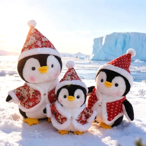 Three plush penguin toys in red Christmas floral outfits on a snowy arctic background