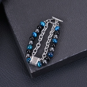 Macro shot of men's double-row bracelet with blue tiger eye stones and silver OT clasp