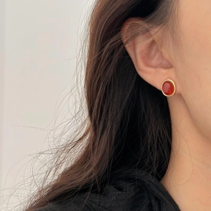 Elegant 925 sterling silver red agate stud earrings with gold plating on female model
