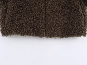 Macro detail of brown faux fur texture and metal zipper on fleece jacket hem