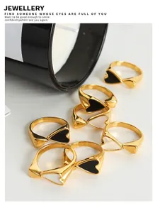Flat lay of 18K gold plated heart rings with black and white enamel inlays