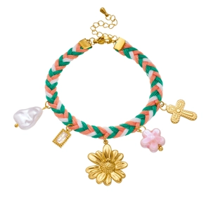 Detail of hand-woven colorful rope bracelet with gold sunflower and pearl charms
