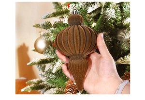Close-up of a brown flocked gourd-shaped Christmas ornament with silver hanger cap