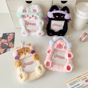 Detailed view of four colorful plush animal photo card holders with plastic clips