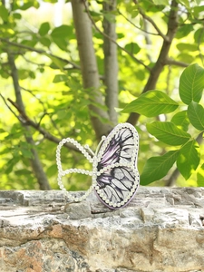 Exquisite purple butterfly clutch bag featuring sparkling rhinestone accents and wing patterns