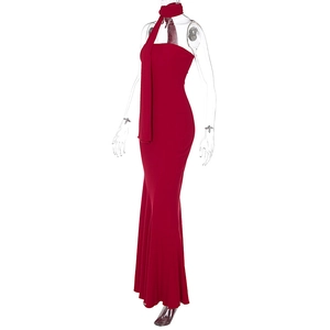 Detail of red strapless maxi dress with matching scarf on a minimalist studio background
