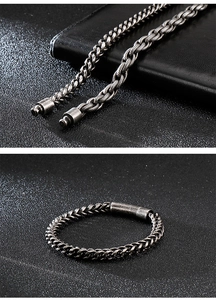Macro view of vintage stainless steel Cuban and braided chain links with plug-in clasp