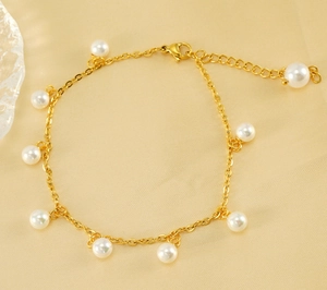 Detail of 18K gold-plated anklet featuring elegant white pearl charms and a lobster clasp
