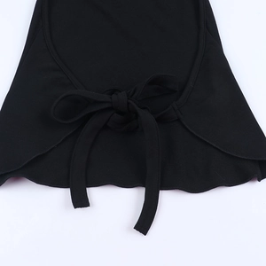 Close-up detail of the black halter knit vest featuring a delicate bow tie ribbon design