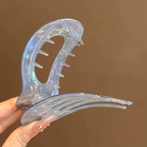 Close-up of iridescent hair claw clip featuring a secure three-row gear tooth design