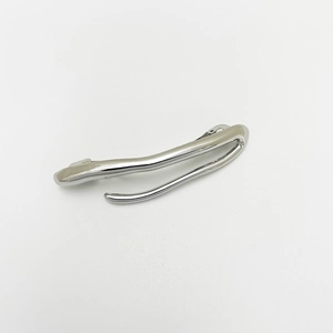 Detailed macro view of a silver irregular punk style hair clip on white background