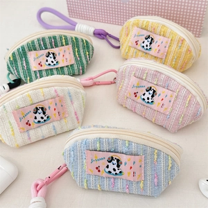 Group shot of colorful woven shell-shaped storage bags with cute dalmatian dog patches