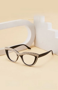 Detailed view of cat-eye reading glasses with hand-set rhinestones on a stylish black frame