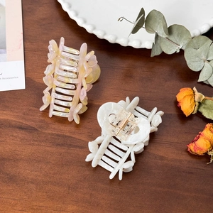 Elegant floral acetate hair claws with mother-of-pearl finish and sparkling rhinestones