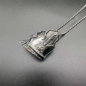 Close-up of vintage stainless steel Odin Viking bell pendant with intricate relief details