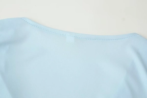 Detailed close-up of V-neck stitching on light blue high waist loose skirt set