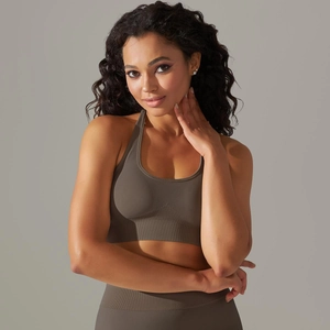 Detail of seamless ribbed hem on dark brown sports bra for high-impact support
