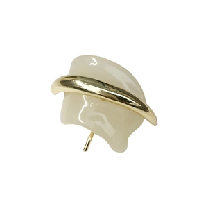 Elegant gold metal arc earring with cream resin charm on a professional white background