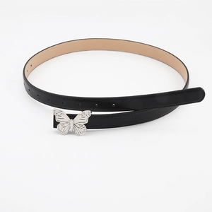 Detail of a black leather belt featuring a polished silver butterfly buckle and texture