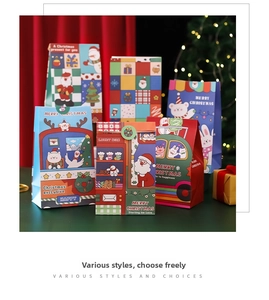 Close-up of festive Christmas gift bags with colorful Santa, deer, and snowman illustrations