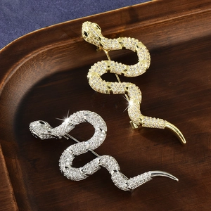 Luxury snake brooch pins with gold and silver finish encrusted in crystals and green gems
