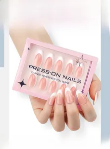 Close-up of pink French tip press-on nails in a branded packaging box
