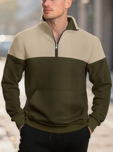 Close-up of men's half-zip sweatshirt with beige diamond quilted and olive textured panels