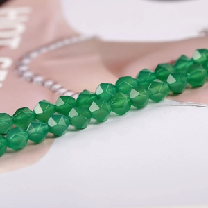 Macro shot of faceted green agate gemstone beads for DIY jewelry making and design