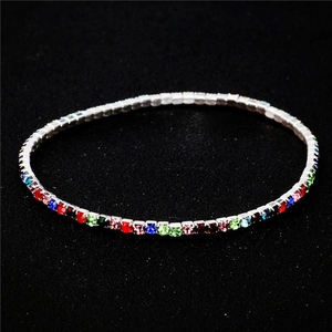 Macro detail of elastic tennis bracelet with colorful crystals and silver base