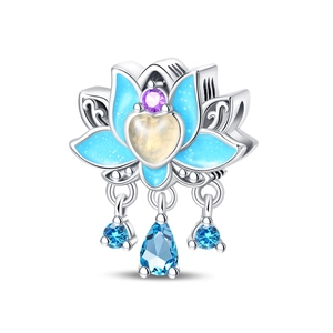 Macro shot of blue enamel lotus charm with purple zircon and teardrop crystal dangles