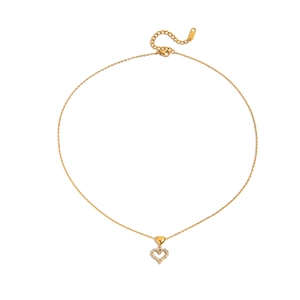 Close-up of golden necklace featuring a solid heart and a zircon-set open heart pendant